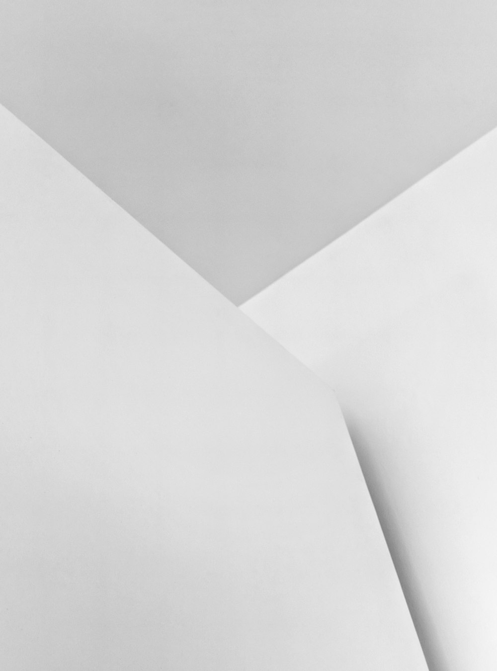 a black and white photo of a clock on a wall