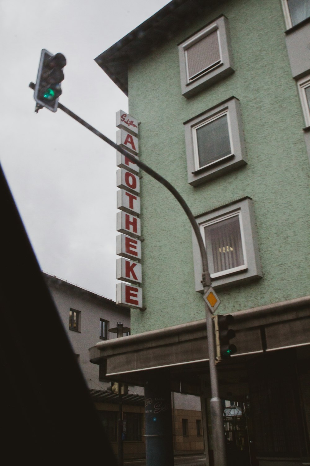 a traffic light on a pole in front of a building