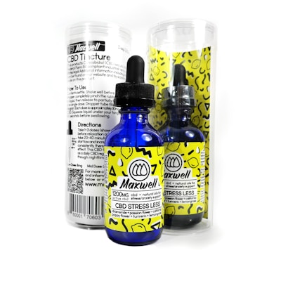 A blue glass dropper bottle labeled 'Maxwell CBD Stress Less' with bright yellow accents and patterns. It is accompanied by a cylindrical clear container that has black text detailing product information and directions. The packaging has a modern and clean design.