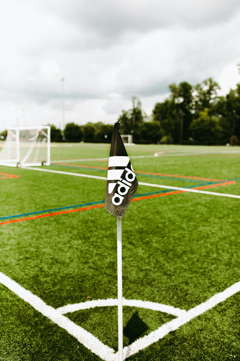 adidas flag on pole on soccer field