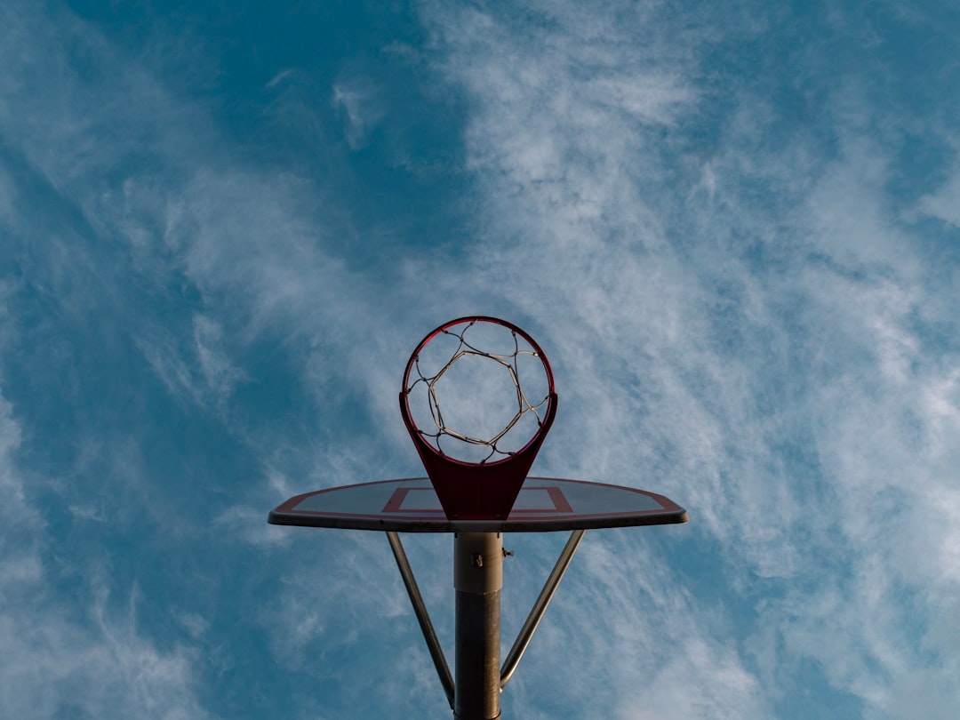basketball hoop under cloudy sky