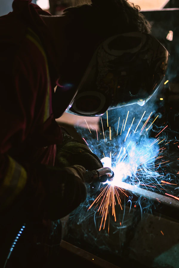 Close-up of welder wearing protective welding mask during precision fabrication work
