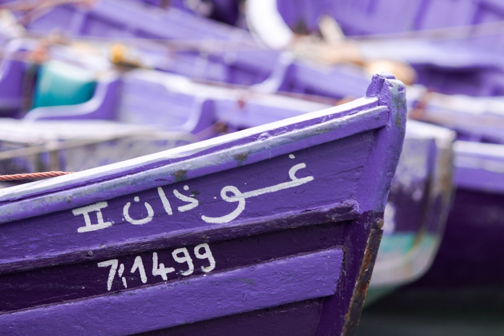 shallow focus photography of purple canoe