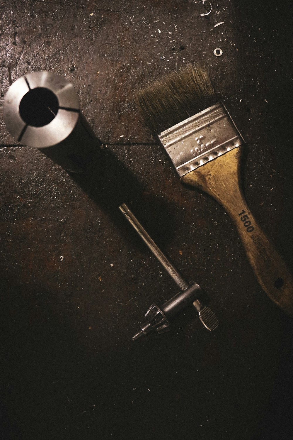 a shaving brush next to a shaving brush on a table