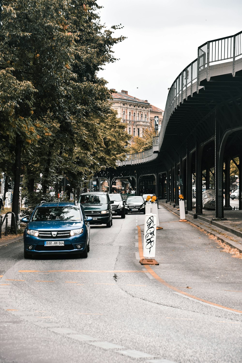 blue vehicle near trees