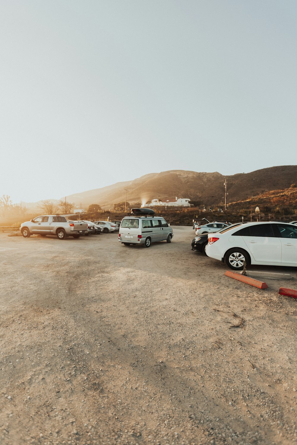 parked vehicles near green mountains