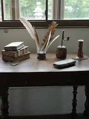Various window styles displayed on a rustic wooden table.