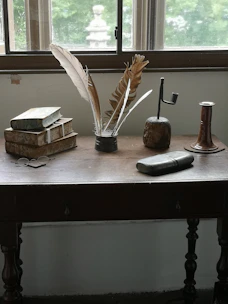 Various window styles displayed on a rustic wooden table.
