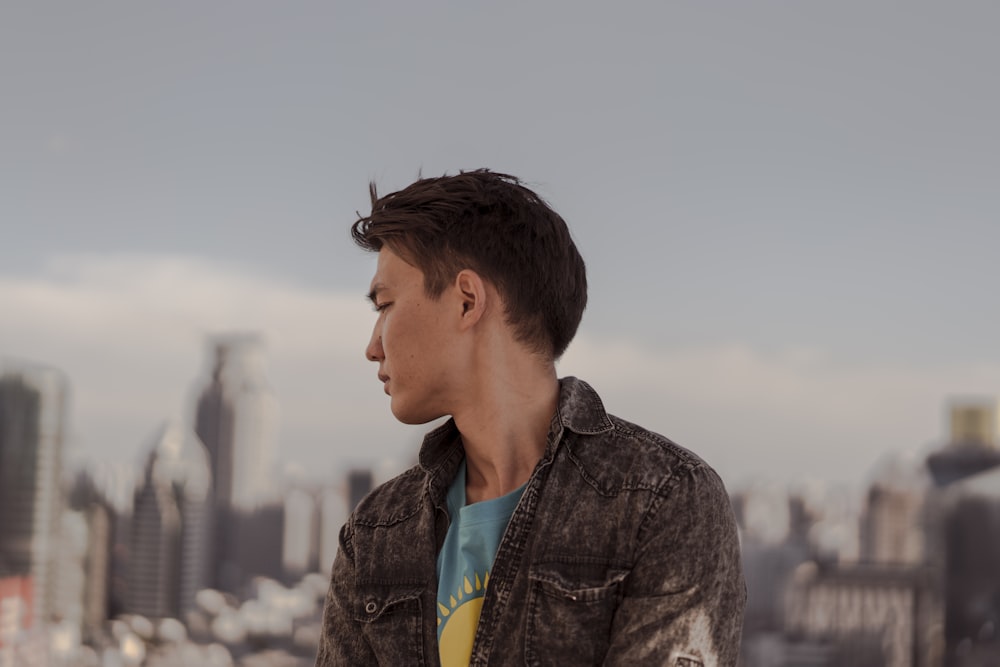 a man standing in front of a city skyline