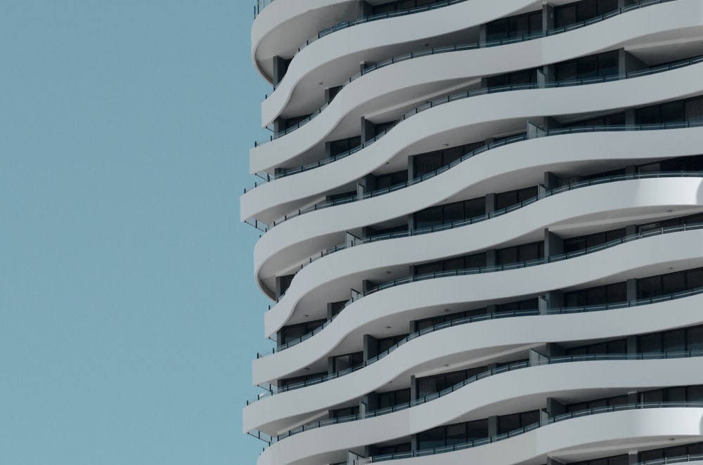 a tall white building with balconies and balconies on it
