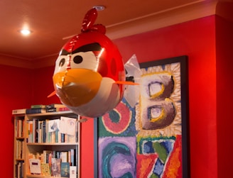 Bright red walls decorated with playful English vocabulary charts and drawings.