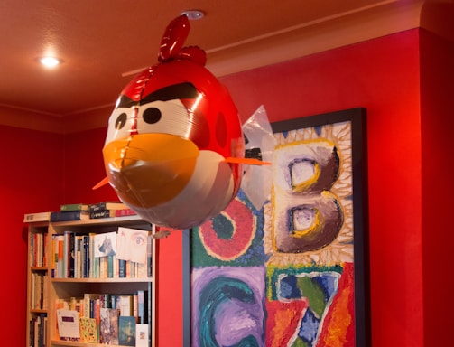 Bright red walls decorated with playful English vocabulary charts and drawings.