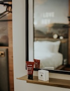 A sleek hotel room minibar styled with elira essentials self-care products arranged neatly.