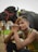 man sitting beside water buffalo