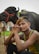 man sitting beside water buffalo