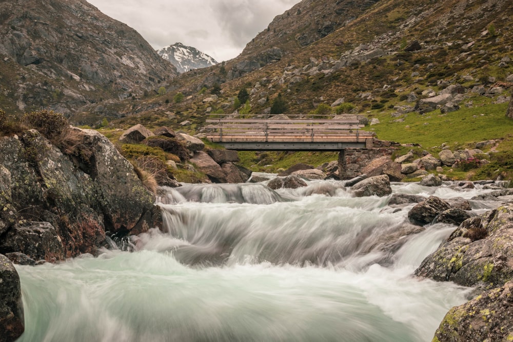 raging waterfalls near bridge