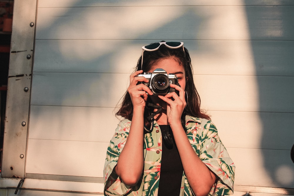 woman taking photo near garage door