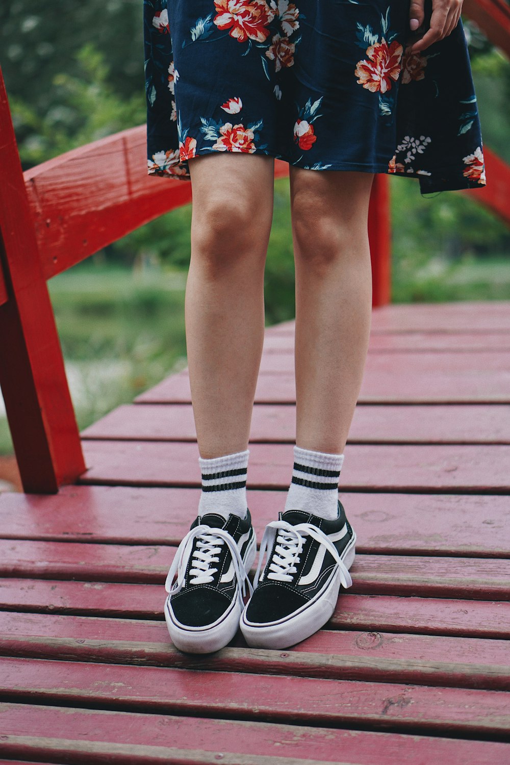 person wearing white-and-black Vans shoes