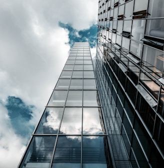 low angle photography of high rise building under cloudy sky