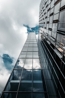 low angle photography of high rise building under cloudy sky