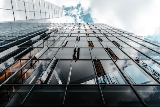 low angle photo of curtain glass wall building
