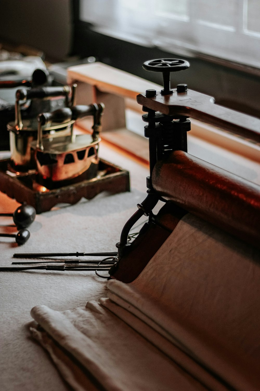 a close up of a clock on a table near a window