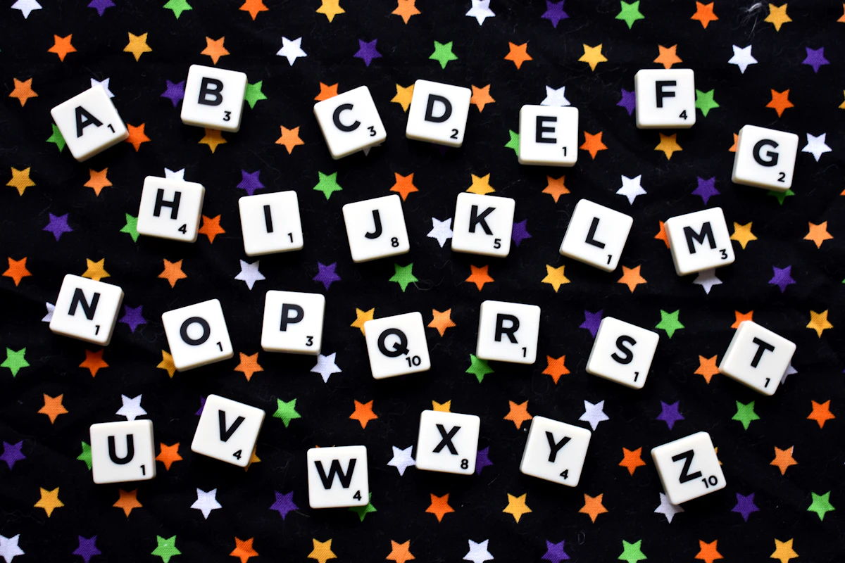 Colorful alphabet Scrabble tiles arranged on a surface, representing word games and vocabulary skill