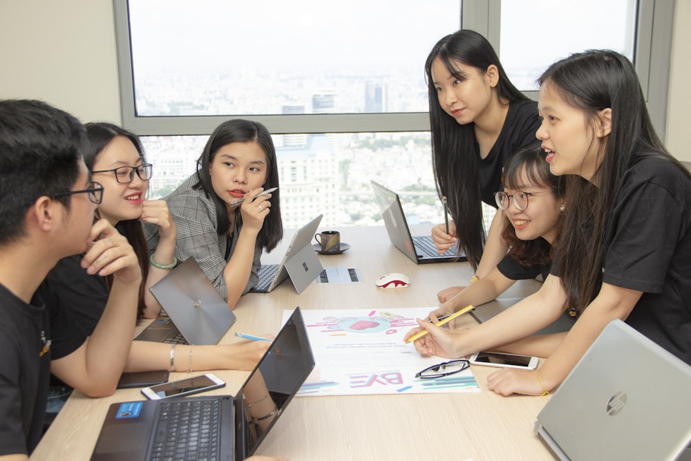 group of people with laptops