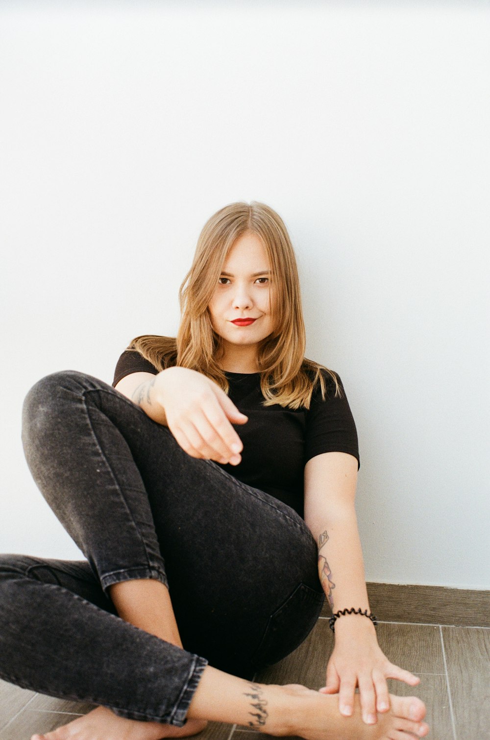 woman leaning on wall