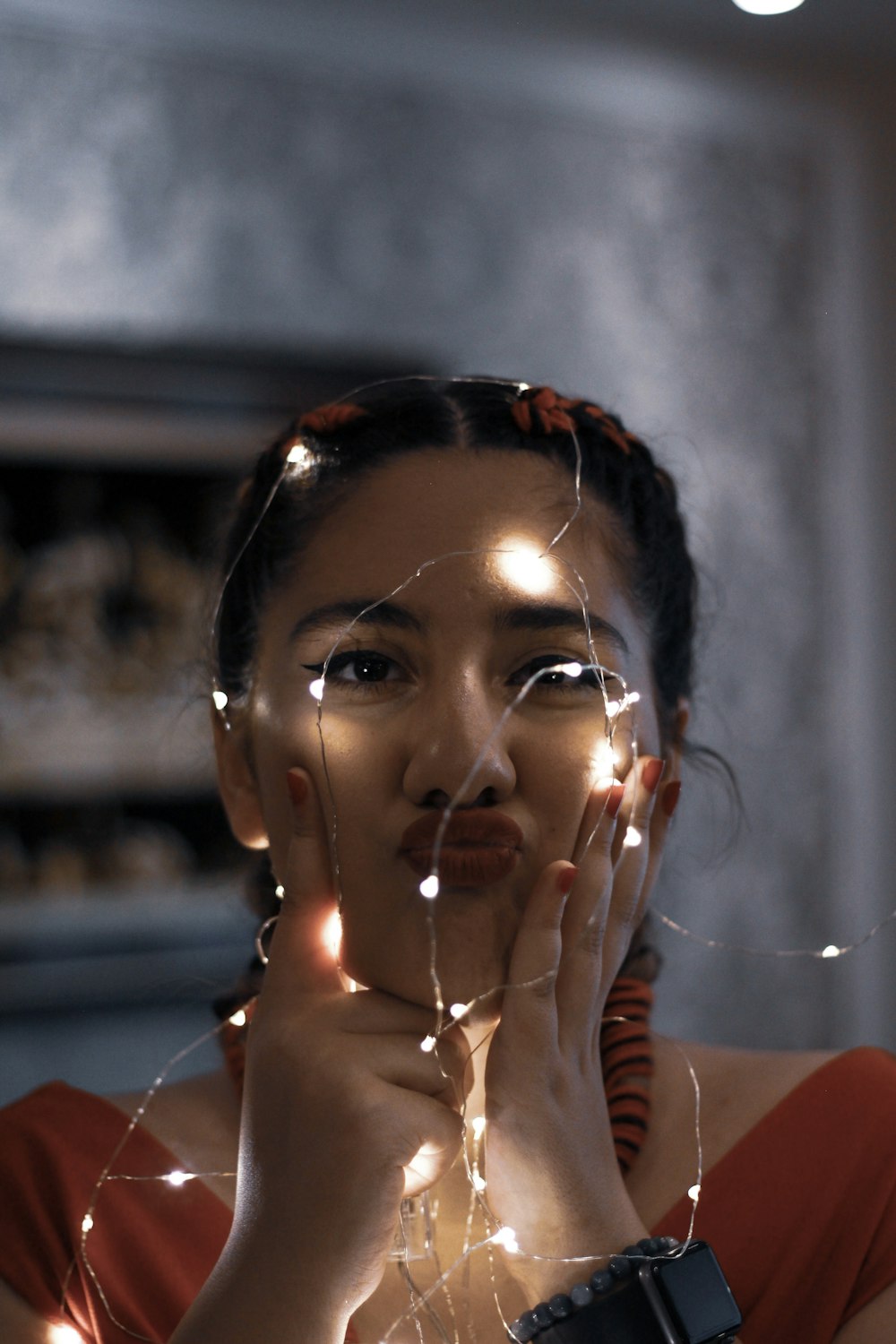 woman holding green string lights