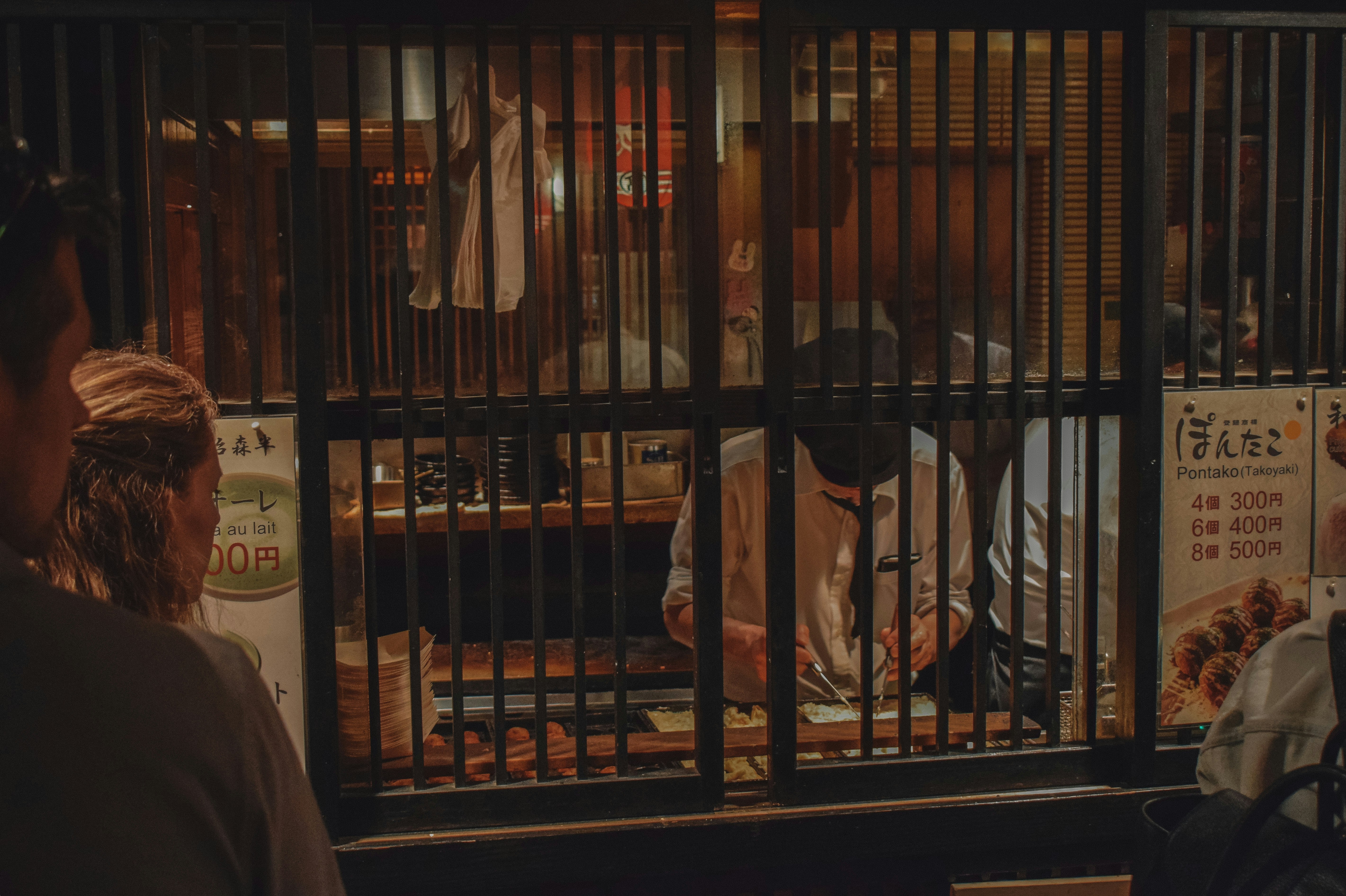 a couple of people standing in front of a jail cell
