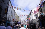 group of people at a street with assorted flags