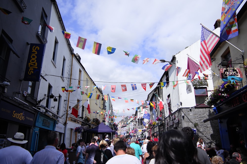 group of people at a street with assorted flags