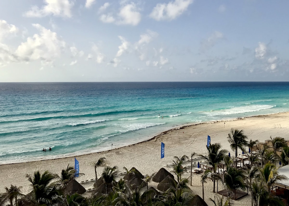 Zona Hotelera Norte Cancun — aerial view of the Hotel Zone strip with turquoise Caribbean on one side and the lagoon on the other
