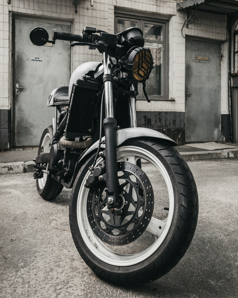 black motorcycle parking near building