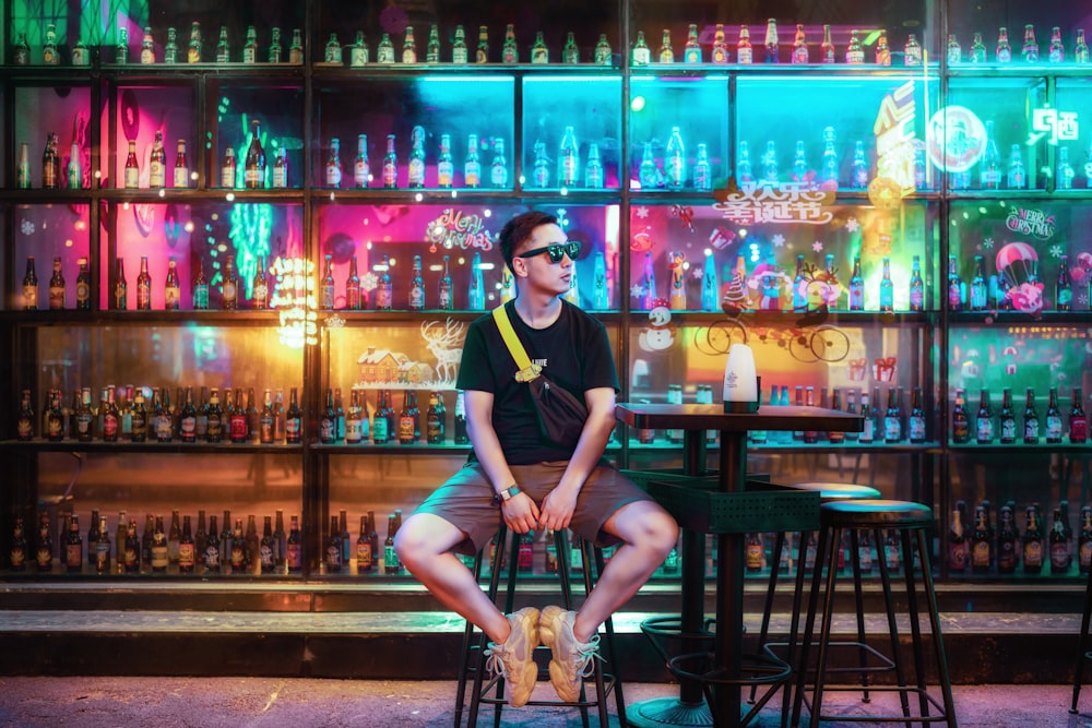 man sitting on bar stool nera table