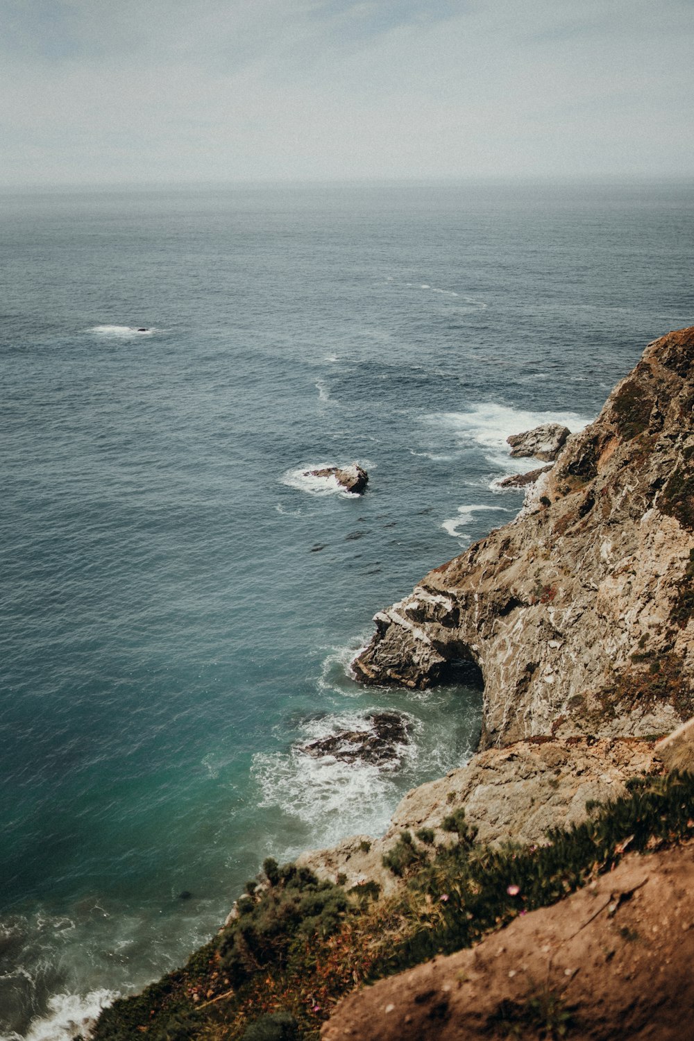 brown cliff near ocean