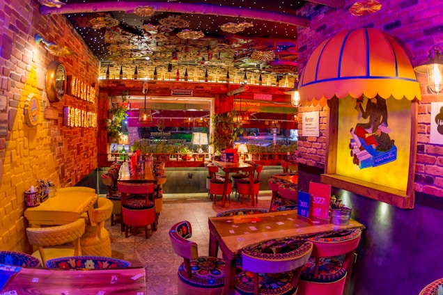 A cozy restaurant interior with vibrant red, yellow, and black decor