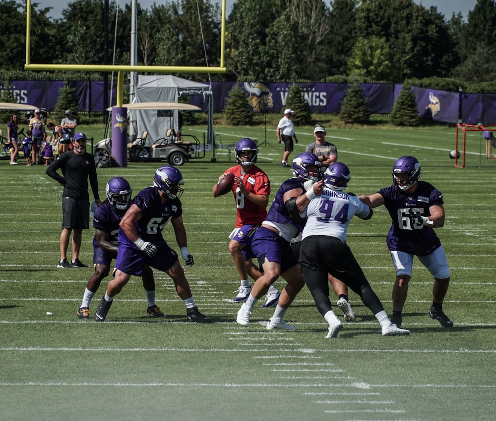 group of people playing football during daytime