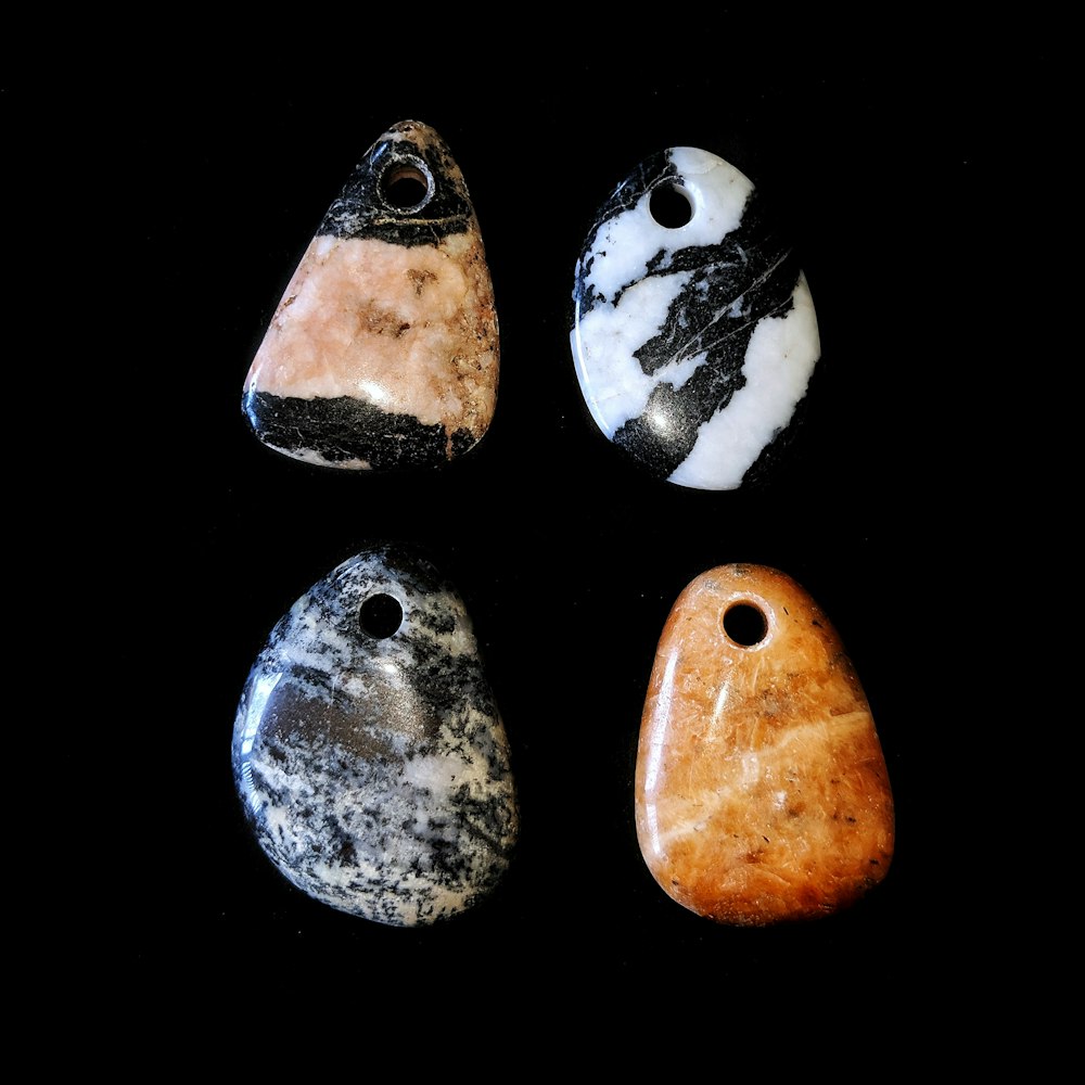 four assorted-color gemstones close-up photography