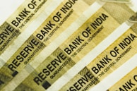 a stack of indian bank notes sitting on top of each other
