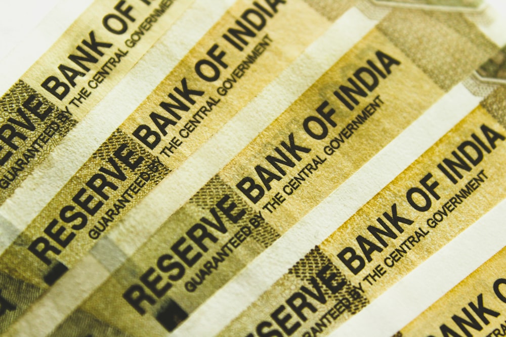 a stack of indian bank notes sitting on top of each other