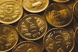 round gold-colored coin lot close-up photography