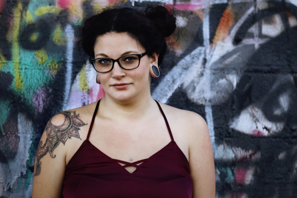 woman wearing maroon halter top and black framed eyeglasses