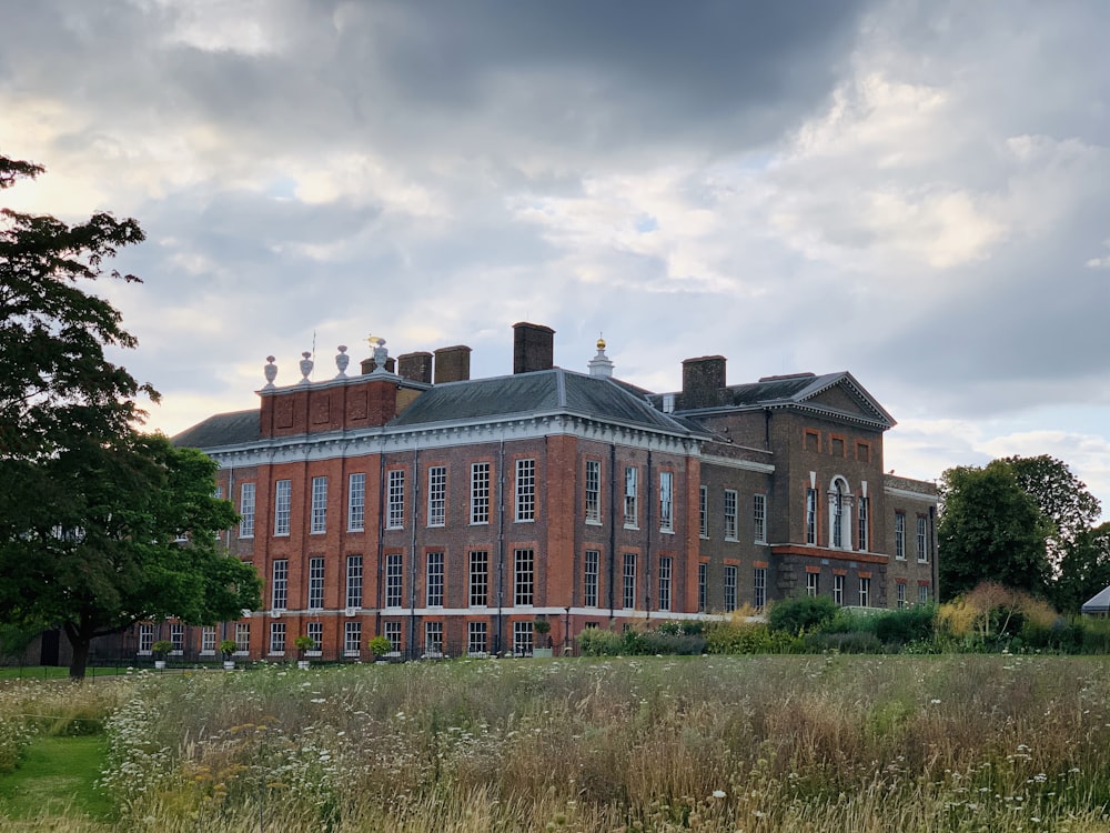 red brick house under cloudy sky at daytime