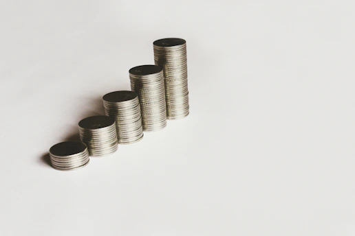 Close-up of hands stacking coins, symbolizing steady income growth.