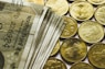 round gold-colored rupee coins and banknotes