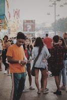 A diverse group of people happily using the f4m app outdoors to find products nearby.