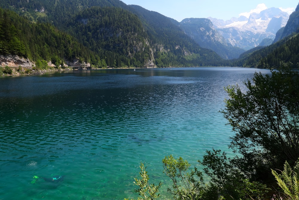 photography of lake and mountain range during daytime