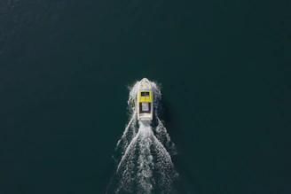 Sleek boat hull cutting through water, showcasing hydrodynamic design in motion.